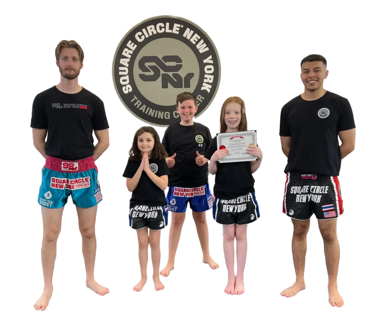 Five people in martial arts attire smiling.