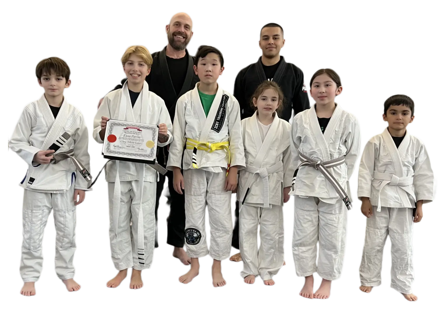 Martial arts students posing in white uniforms.